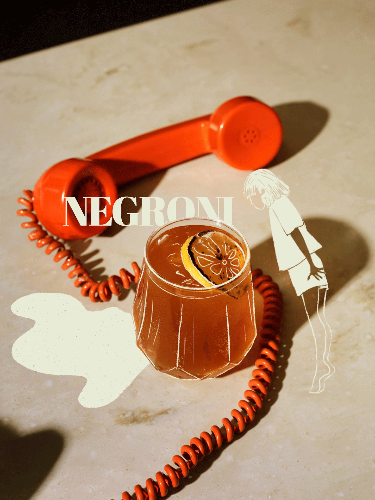 A Negroni cocktail with orange and a vintage rotary phone